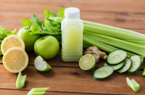 Bottle with Green Juice and Vegetables